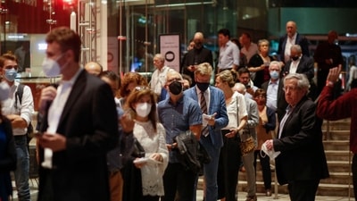 People queue to attend the New York Philharmonic's first concert after its reopening at the Alice Tully Hall in New York, on September 17. Catherine Colson arrived with friends ahead of what she anticipated would be "a memorable night of phenomenal music." "It was a really long year. I feel rejuvenated," she told AFP. "It's like a rebirth in a way." (Kena Betancur / AFP)