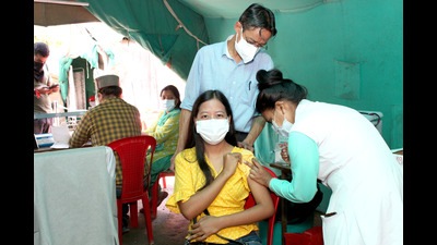 A health worker administering a dose of Covid-19 vaccine at the district hospital in Kullu on Saturday. (Aqil Khan/HT)