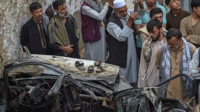 Afghan residents and family members of the victims gather next to a damaged vehicle inside a house, day after a US drone airstrike in Kabul on August 30. (AFP) Afghan residents and family members of the victims gather next to a damaged vehicle inside a house, day after a US drone airstrike in Kabul on August 30. (AFP)