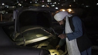 A Taliban fighter checks the trunk of a car at a checkpoint in Kabul, Afghanistan. (AP file photo) A Taliban fighter checks the trunk of a car at a checkpoint in Kabul, Afghanistan. (AP file photo)