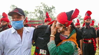 At the passing out parade, some family could not hide their pride at their ward making it to the army. (PTI) At the passing out parade, some family could not hide their pride at their ward making it to the army. (PTI)