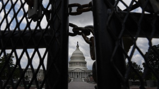 The black fence that surrounded the US Capitol building for six months following the January 6 riots has been brought back ahead of the rally along with surveillance cameras.(AFP)