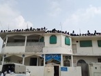 Supporters of radical cleric Maulana Abdul Aziz seen gathered at the rooftop in Jamia Hafsa. Miscreants inside the seminary along with Aziz hoisted the Taliban flag at Jamia Hafsa. Supporters of radical cleric Maulana Abdul Aziz seen gathered at the rooftop in Jamia Hafsa. Miscreants inside the seminary along with Aziz hoisted the Taliban flag at Jamia Hafsa. 
