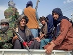 Taliban forces patrol near the entrance gate of Hamid Karzai International Airport in Kabul, Afghanistan. Taliban forces patrol near the entrance gate of Hamid Karzai International Airport in Kabul, Afghanistan. 