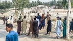 Taliban members and people gather at the site of a bomb explosion on Sunday. (AFP) Taliban members and people gather at the site of a bomb explosion on Sunday. (AFP)