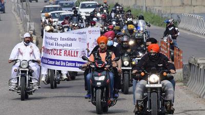 Residents, along with Punjab Police Academy, Phillaur, carrying out a motorcycle rally in Ludhiana on Sunday. (Harsimar Pal Singh/HT)