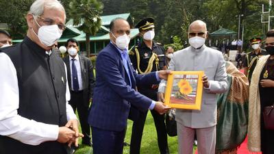 Himachal chief minister Jai Ram Thakur presenting a souvenir to President Ram Nath Kovind as governor Rajendra Vishwanath Arlekar looks on at Annadale helipad in Shimla on Sunday. (Deepak Sansta/HT)
