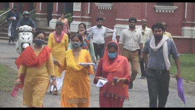 Candidates coming out of a centre after the UPPSC’s lecturer recruitment exam in Prayagraj on Sunday. (HT PHOTO)