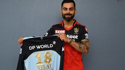 Virat Kohli with RCB's blue jersey (RCB Twitter) Virat Kohli with RCB's blue jersey (RCB Twitter)