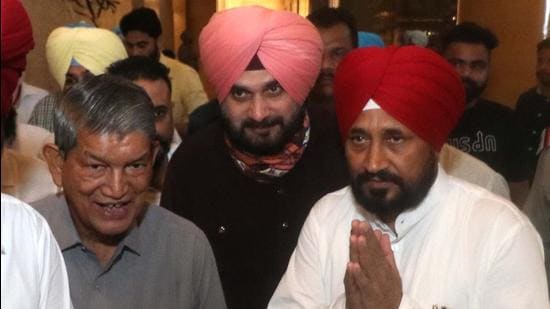 Former Uttarakhand CM and Punjab Congress affairs in-charge Harish Rawat, PPCC president Navjot Singh Sidhu with Punjab CM designate Charanjit Singh Channi in Chandigarh on Sunday. (Keshav Singh/HT) Former Uttarakhand CM and Punjab Congress affairs in-charge Harish Rawat, PPCC president Navjot Singh Sidhu with Punjab CM designate Charanjit Singh Channi in Chandigarh on Sunday. (Keshav Singh/HT)