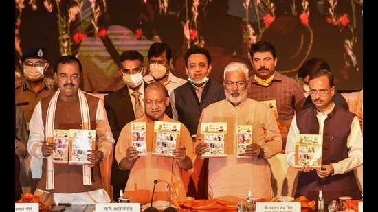 Uttar Pradesh chief minister Yogi Adityanath releasing a book on completing 4.5 years of his government at Lok Bhawan in Lucknow on Sunday. Deputy CM Dinesh Sharma, K P Mauriya and BJP state president Swatantra Dav are also seen. (PTI)