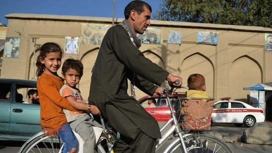 A man along with children rides a bicycle in Kabul (AFP/Used only for representative purpose)