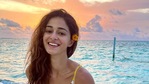Ananya Panday posing with a yellow flower behind her ear. Ananya Panday posing with a yellow flower behind her ear.