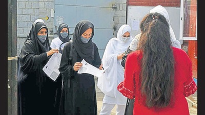 Students produce their vaccination certificates before entering a college premises in Srinagar on Monday. (ANI) Students produce their vaccination certificates before entering a college premises in Srinagar on Monday. (ANI)
