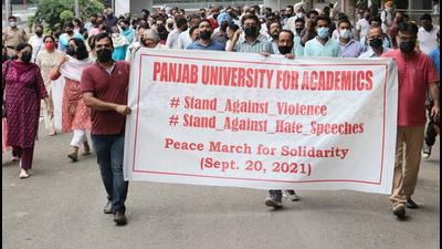 Faculty members, employees and students of Panjab University taking out a peace march on the campus on Monday. (HT Photo)