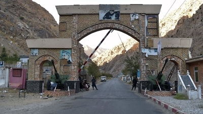 Taliban fighters stands guard at the entrance gate of Panjshir province. (AFP Photo) Taliban fighters stands guard at the entrance gate of Panjshir province. (AFP Photo)