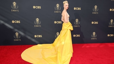 Anya Taylor-Joy attends the 73rd Primetime Emmy Awards wearing a white Christian Dior Haute Couture floor-sweeping dress with a dramatic yellow shawl. She went old-Hollywood glamour with her look by wearing her locks in a top bun. (AFP) Anya Taylor-Joy attends the 73rd Primetime Emmy Awards wearing a white Christian Dior Haute Couture floor-sweeping dress with a dramatic yellow shawl. She went old-Hollywood glamour with her look by wearing her locks in a top bun. (AFP)