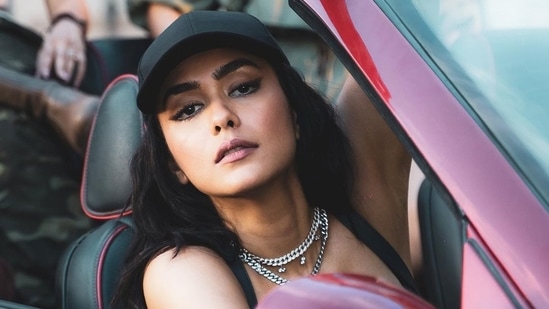 Leaving her luscious black permed tresses open down her cap, Mrunal completed her attire with a pair of handcrafted leather boots from Saint G and accessorised her look with a Marquise link choker and link chain from A.Hedo and a black cap.(Instagram/mrunalthakur)