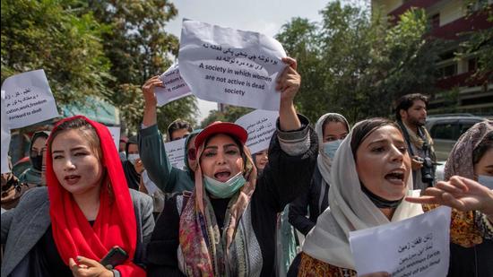 Afghan women hold placards during a demonstration demanding better rights for women in front of the former ministry of women affairs in Kabul on September 19. (AFP)