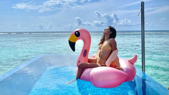Ananya posing on a flamingo floatie.