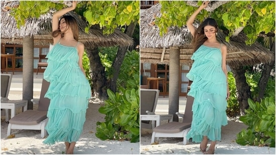 Mouni chose a tiered tulle dress in a light green shade for the beach photoshoot. The strappy ensemble featured multiple tiers, self-pleated details and a billowy silhouette, (Instagram/@imouniroy)