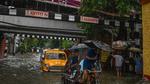 Commuters make their way along a waterlogged street after heavy rainfall in Kolkata on September 20. (AFP) Commuters make their way along a waterlogged street after heavy rainfall in Kolkata on September 20. (AFP)