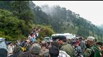 Police personnel and locals at the site where an Indian Army helicopter crashed in Udhampur district on Tuesday. (PTI) Police personnel and locals at the site where an Indian Army helicopter crashed in Udhampur district on Tuesday. (PTI)
