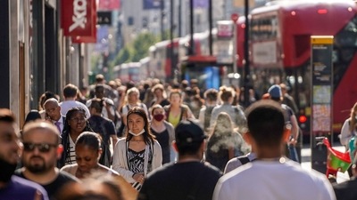 Pedestrians, some wearing face coverings due to Covid-19, walk past shops on Oxford Street in central London on June 7, 2021. (Used for representative purpose only_