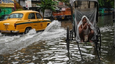 A rickshaw-puller wraps himself with plastic sheet while waiting to ferry customers across a waterlogged streets of Kolkata. (AFP) A rickshaw-puller wraps himself with plastic sheet while waiting to ferry customers across a waterlogged streets of Kolkata. (AFP)