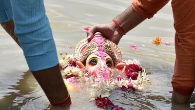 Nine contractual employees of Indore civic body were booked on Tuesday for allegedly disrespecting Ganpati idols collected from people by throwing them into a pond for immersion, Madhya Pradesh police said. (HT photo) Nine contractual employees of Indore civic body were booked on Tuesday for allegedly disrespecting Ganpati idols collected from people by throwing them into a pond for immersion, Madhya Pradesh police said. (HT photo)