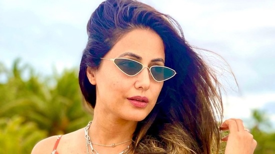 Made of crepe fabric, Hina paired it with similar coloured bell bottom pants and layered them with a sunflower orange cape.(Instagram/realhinakhan)