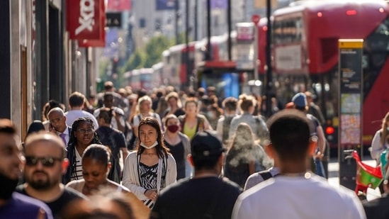 Pedestrians, some wearing face coverings due to Covid-19, walk past shops on Oxford Street in central London on June 7, 2021. (Used for representative purpose only_ Pedestrians, some wearing face coverings due to Covid-19, walk past shops on Oxford Street in central London on June 7, 2021. (Used for representative purpose only_