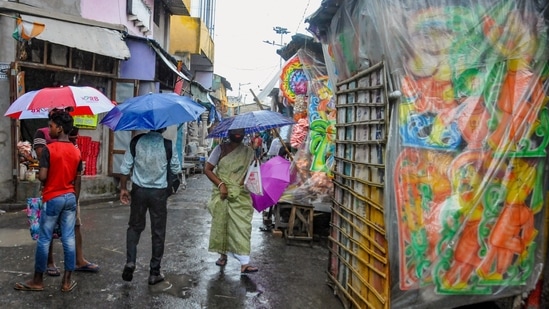 Decorative items of Goddess Durga covered in plastic during rain ahead of Durga Puja festival, at Kumartuly in Kolkata.(PTI)