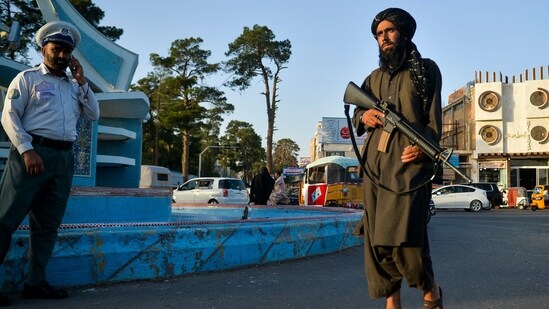 In this picture taken on September 19, 2021, a Taliban fighter (R) patrols along a street in Herat.&nbsp;(AFP)