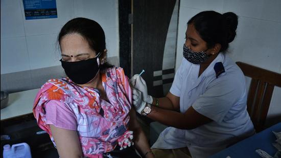 A beneficiary gets inoculated against Covid-19 at CR Wadia hospital vaccination centre in Thane. (HT file)