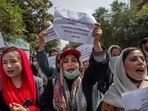 Afghan women hold placards during a demonstration demanding better rights for women in front of the former ministry of women affairs in Kabul. Afghan women hold placards during a demonstration demanding better rights for women in front of the former ministry of women affairs in Kabul.