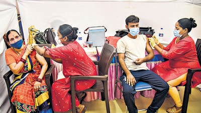 Healthcare workers inoculate Covid-19 vaccine to beneficiaries during a vaccination camp at Valia College in Mumbai on Tuesday. The UK government on Wednesday added Covishield as one of the vaccines it will recognise when allowing international travellers to skip quarantine on arrival. (PTI) Healthcare workers inoculate Covid-19 vaccine to beneficiaries during a vaccination camp at Valia College in Mumbai on Tuesday. The UK government on Wednesday added Covishield as one of the vaccines it will recognise when allowing international travellers to skip quarantine on arrival. (PTI)