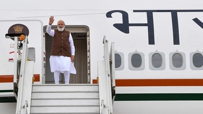 PM Modi gesturing from a plane as he leaves for the US for a five-day visit. (PIB Photo) PM Modi gesturing from a plane as he leaves for the US for a five-day visit. (PIB Photo)