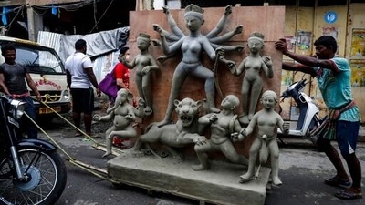 Laborers transport an unfinished clay image of Hindu goddess Durga in Kolkata. (AP) Laborers transport an unfinished clay image of Hindu goddess Durga in Kolkata. (AP)