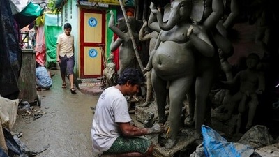 An artisan works on a clay idol of elephant headed Hindu god Ganesh as part of Durga Puja festival preparations in Kolkata. (AP) An artisan works on a clay idol of elephant headed Hindu god Ganesh as part of Durga Puja festival preparations in Kolkata. (AP)