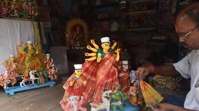 An artist dacorates an idol of Goddess Durga ahead of Durga Puja festival at Kumartuly in Kolkata. (PTI) An artist dacorates an idol of Goddess Durga ahead of Durga Puja festival at Kumartuly in Kolkata. (PTI)