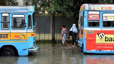 Commuters wade through a waterlogged road after heavy rains in Kolkata, on Tuesday, (PTI) Commuters wade through a waterlogged road after heavy rains in Kolkata, on Tuesday, (PTI)