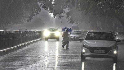 A person crosses the road during rain at Janpath on Tuesday. (Raj K Raj/HT Photo) A person crosses the road during rain at Janpath on Tuesday. (Raj K Raj/HT Photo)