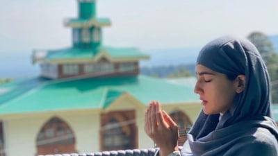 Sara in prayer outside a mosque. Sara in prayer outside a mosque.
