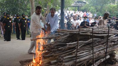 Father of Major Anuj Rajput performing his last rites at the Sector-20 cremation ground in Panchkula on Wednesday. (Sant Arora/HT)