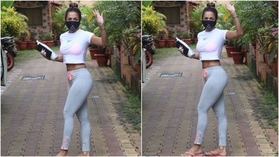 Malaika's tights came in a grey shade and featured a contrasting neon orange piping and drawstring detail. She rounded off her workout look with a black printed face mask and neon orange flip flops. (HT Photo/Varinder Chawla)