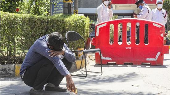 A relative of a coronavirus disease victim outside a hospital in Delhi. (PTI)