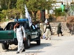 Taliban members inspect near the site of a blast in Jalalabad. Taliban members inspect near the site of a blast in Jalalabad.