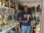 Edosonmwan William, bronze caster, is seen with one of his works inside is gallery at Igun street, Benin City, Nigeria &nbsp;