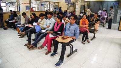 People wait at Regional Passport Office on SB road in Pune. (File photo)